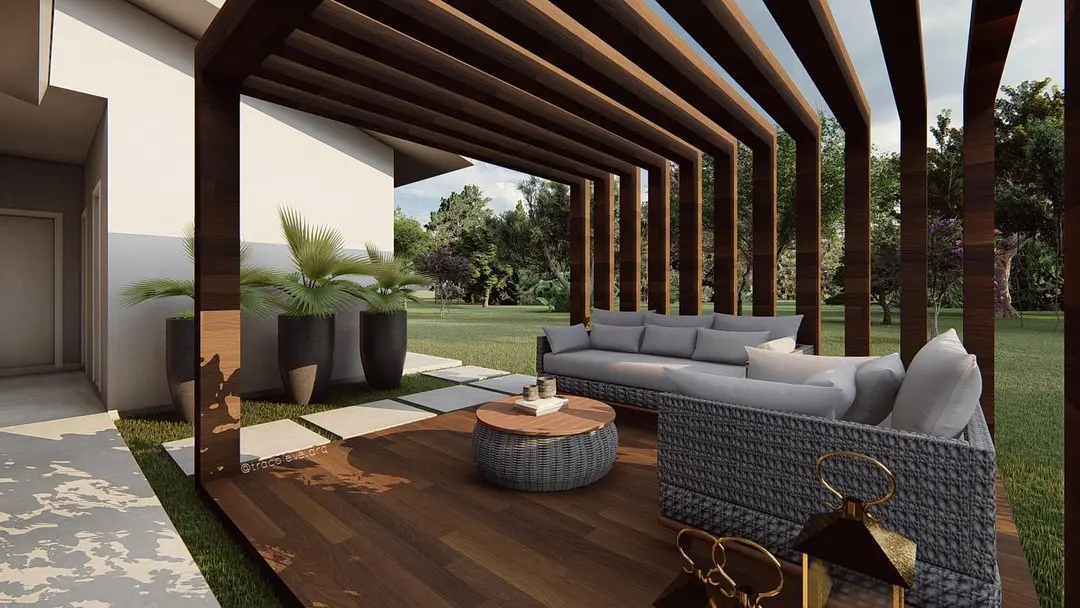 Render do estar sobre deck de madeira, com sofás, mesa redonda e estrutura de pergolado